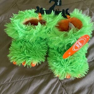Green Fuzzy Monster Slippers with Orange Accents